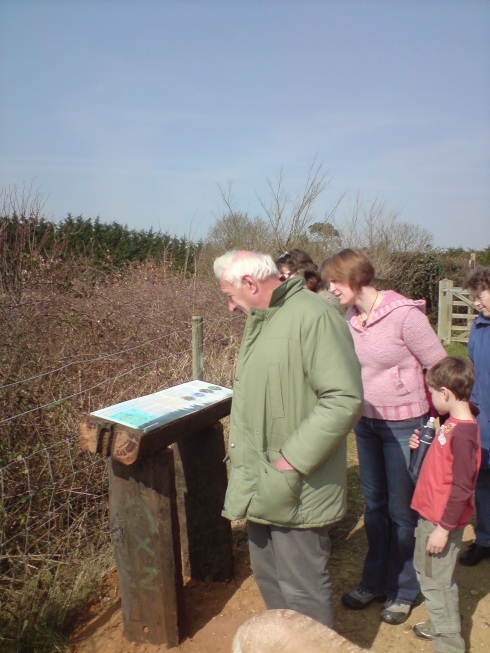 Walkers taking an interest in a new information panel